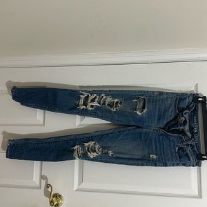 Tight blue stretchy ripped jeans, Size-4 (small). Medium rise jeans.